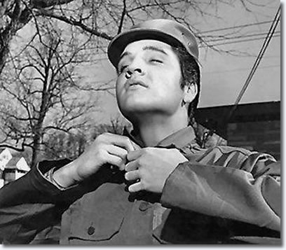 4- Elvis tried on some military clothes provided by a photographer - George Barker of The Tennessean.