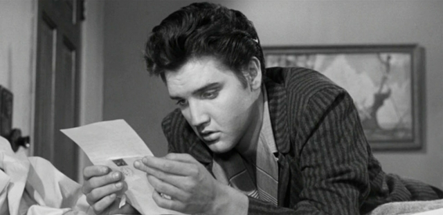 Elvis-Presley-as-Vince-Everett-reading-fan-mail.-Initial-theatrical-wide-release-November-8-1957