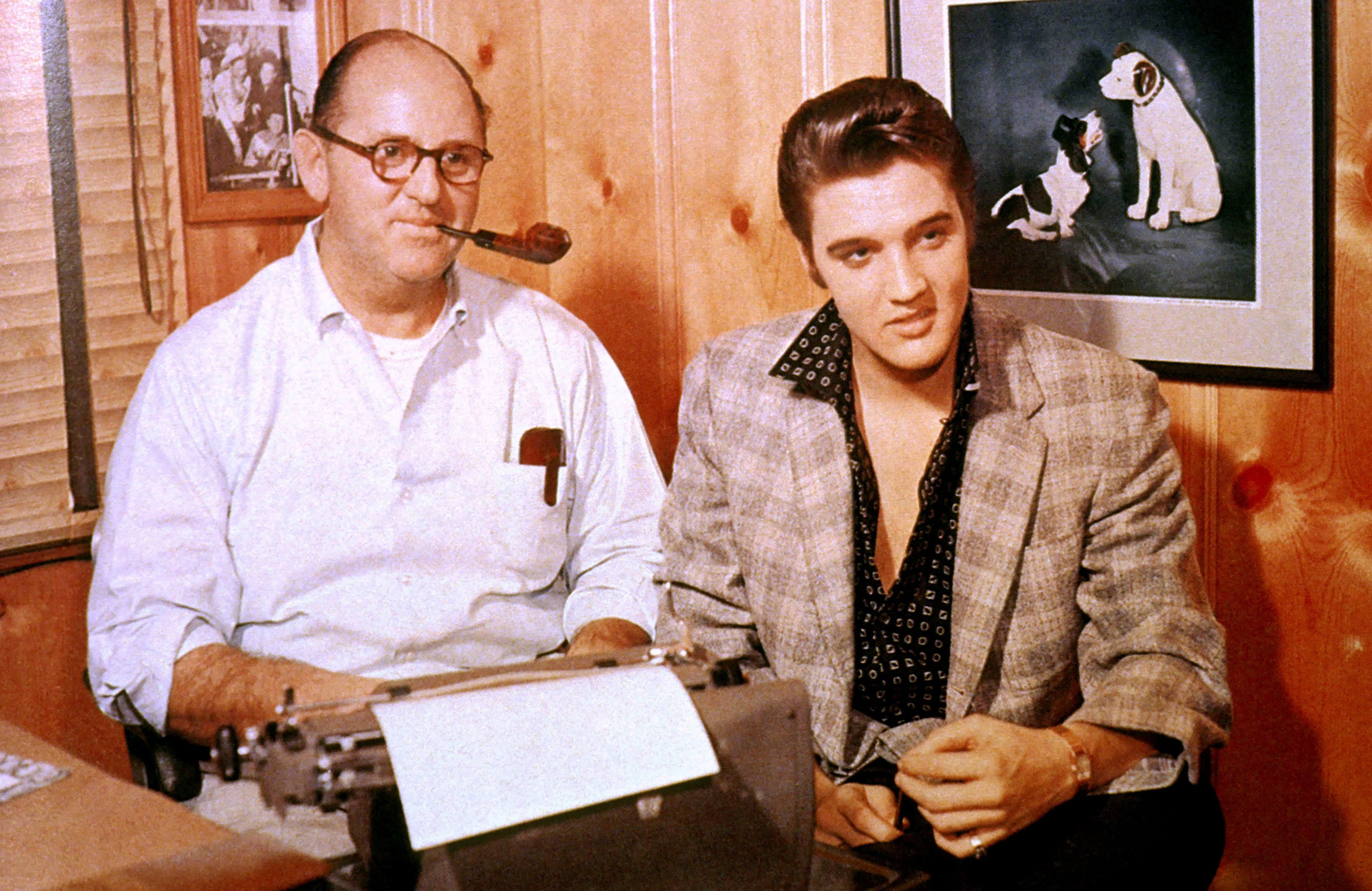 Colonel Tom Parker and Elvis Presley in October 1955 signing a record contract with RCA Victor. *** USA ONLY *** © Glenn A. Baker / Redferns / Retna Ltd