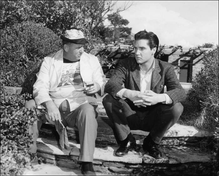 Elvis Presley and Colonel Tom Parker chatting during a break on the set " Wild in Country"