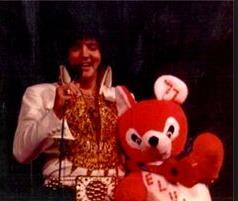 Elvis on stage in Charlotte in february 20 1977. Receiving gifts from fans.