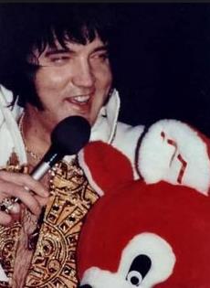 Elvis on stage in Charlotte in february 20 1977. Receiving gifts from fans.