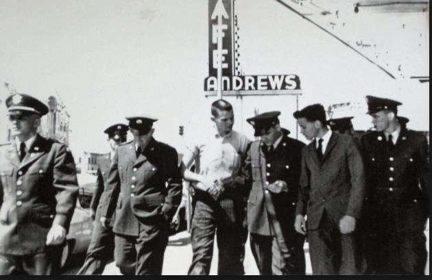 Elvis Presley in uniform, shaking hands, as he left Andrews Cafe on his way to Fort Hood, March 28, 1958