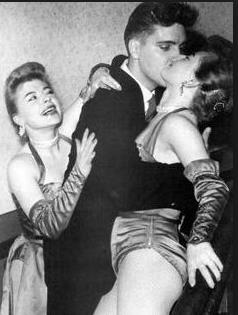 Elvis Presley is pictured with the Orkowski twins at the Moulin Rouge in Munich Germany on Wednesday March 4, 1959