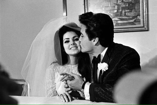 Elvis carrying Priscilla over the threshold.